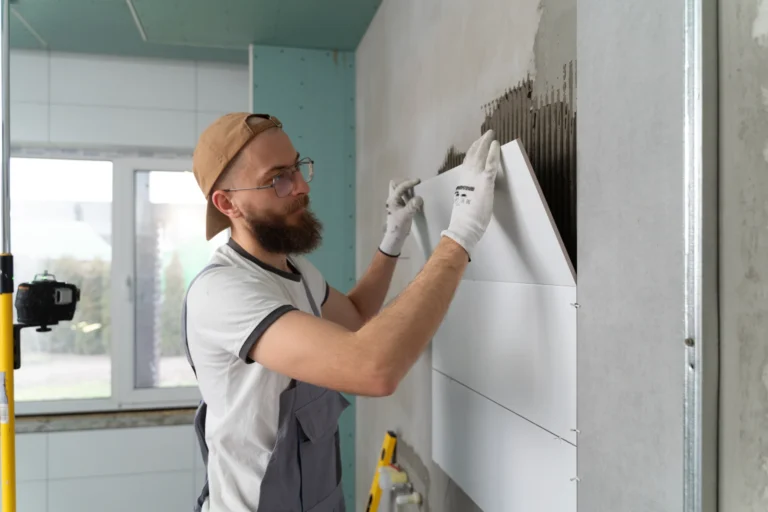 Professional tile installer working on bathroom floor